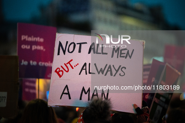 A demonstrator holds a placard reading ''not all men but always a man'' during a protest to condemn violence against women, called by femini...