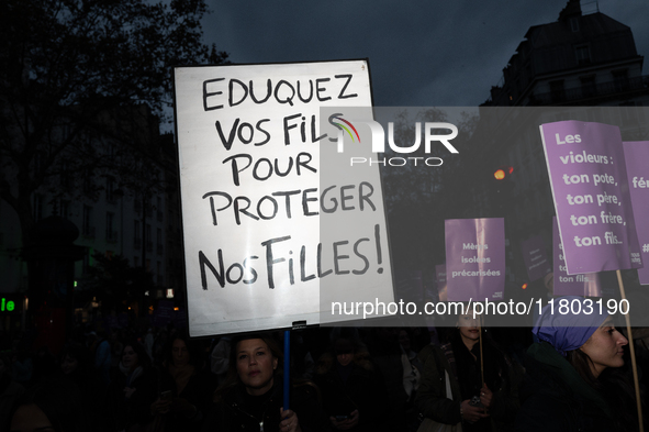 A demonstrator holds a placard reading ''educate your sons to protect our daughters'' during a protest to condemn violence against women, ca...