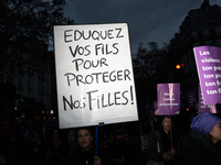 A demonstrator holds a placard reading ''educate your sons to protect our daughters'' during a protest to condemn violence against women, ca...