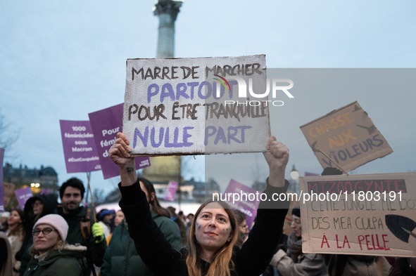 A demonstrator holds a placard reading ''Fed up with walking everywhere for no peace of mind'' during a protest to condemn violence against...