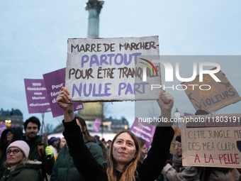 A demonstrator holds a placard reading ''Fed up with walking everywhere for no peace of mind'' during a protest to condemn violence against...