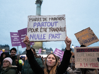 A demonstrator holds a placard reading ''Fed up with walking everywhere for no peace of mind'' during a protest to condemn violence against...