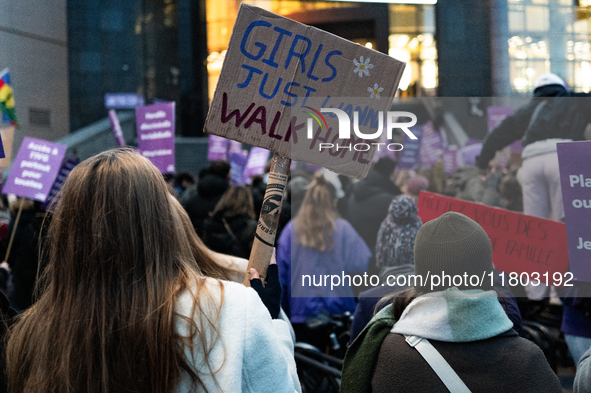 A demonstrator holds a placard reading ''girls just wanna go home'' during a protest to condemn violence against women, called by feminist o...