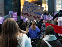 A demonstrator holds a placard reading ''girls just wanna go home'' during a protest to condemn violence against women, called by feminist o...