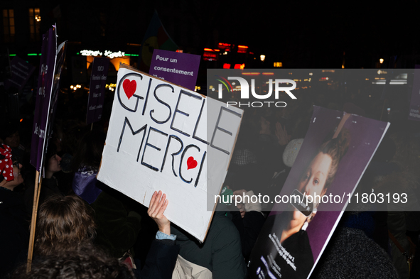 A demonstrator holds a placard reading ''Gisele Thank you'' during a protest to condemn violence against women, called by feminist organizat...