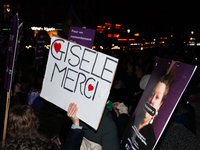 A demonstrator holds a placard reading ''Gisele Thank you'' during a protest to condemn violence against women, called by feminist organizat...