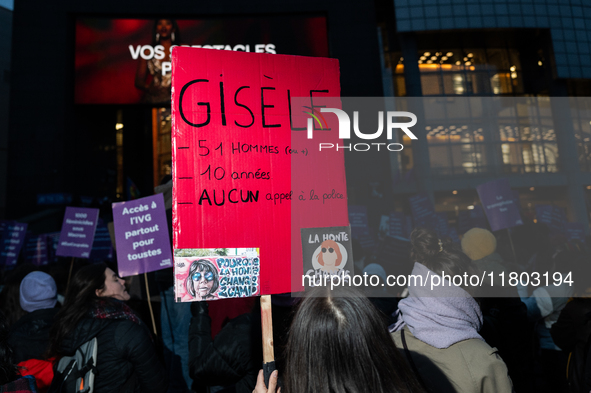 A demonstrator holds a placard reading ''Gisele, 51 men, 10 years old, no police call.'' during a protest to condemn violence against women,...