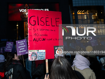 A demonstrator holds a placard reading ''Gisele, 51 men, 10 years old, no police call.'' during a protest to condemn violence against women,...