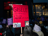 A demonstrator holds a placard reading ''Gisele, 51 men, 10 years old, no police call.'' during a protest to condemn violence against women,...