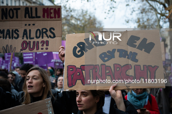 A demonstrator holds a placard reading ''grab them by the patriarchy'' during a protest to condemn violence against women, called by feminis...