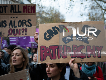 A demonstrator holds a placard reading ''grab them by the patriarchy'' during a protest to condemn violence against women, called by feminis...