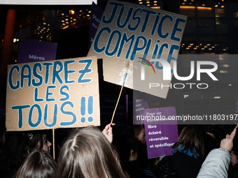 A demonstrator holds a placard reading ''justice complice'' during a protest to condemn violence against women, organized by feminist organi...