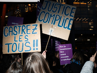 A demonstrator holds a placard reading ''justice complice'' during a protest to condemn violence against women, organized by feminist organi...