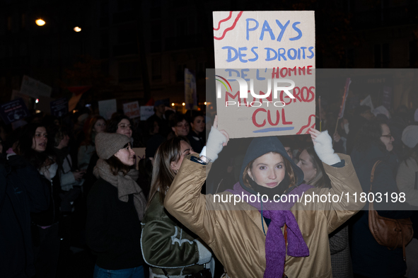 A demonstrator holds a placard reading ''land of human rights, my fat arse'' during a protest to condemn violence against women, organized b...