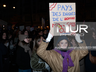 A demonstrator holds a placard reading ''land of human rights, my fat arse'' during a protest to condemn violence against women, organized b...