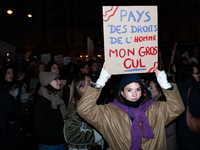 A demonstrator holds a placard reading ''land of human rights, my fat arse'' during a protest to condemn violence against women, organized b...