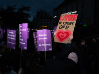 A demonstrator holds a placard reading ''love only hits the heart'' during a protest to condemn violence against women, called by feminist o...