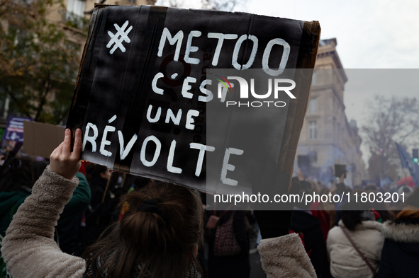 A demonstrator holds a placard reading ''metoo is a revolt'' during a protest to condemn violence against women, called by feminist organiza...