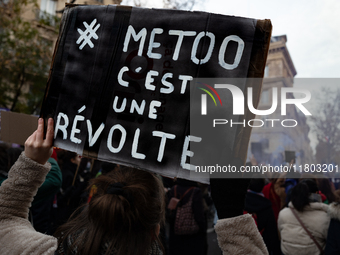 A demonstrator holds a placard reading ''metoo is a revolt'' during a protest to condemn violence against women, called by feminist organiza...