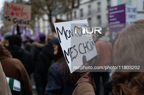 A demonstrator holds a placard reading ''my body my choices'' during a protest to condemn violence against women, called by feminist organiz...