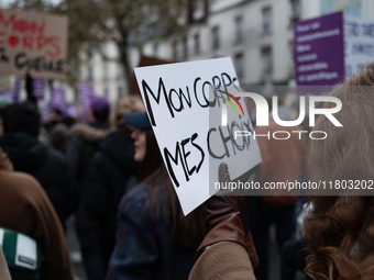 A demonstrator holds a placard reading ''my body my choices'' during a protest to condemn violence against women, called by feminist organiz...