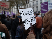 A demonstrator holds a placard reading ''my body my choices'' during a protest to condemn violence against women, called by feminist organiz...