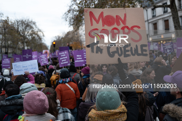 A demonstrator holds a placard reading ''my body, shut up'' during a protest to condemn violence against women, called by feminist organizat...