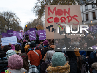 A demonstrator holds a placard reading ''my body, shut up'' during a protest to condemn violence against women, called by feminist organizat...