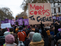 A demonstrator holds a placard reading ''my body, shut up'' during a protest to condemn violence against women, called by feminist organizat...