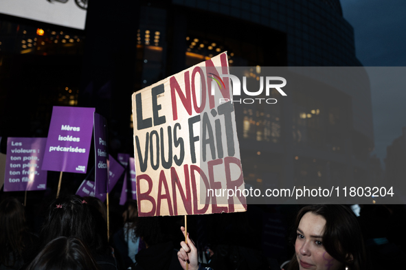 A demonstrator holds a placard reading ''no gives you a hard-on'' during a protest to condemn violence against women, called by feminist org...