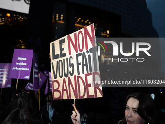 A demonstrator holds a placard reading ''no gives you a hard-on'' during a protest to condemn violence against women, called by feminist org...