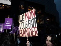 A demonstrator holds a placard reading ''no gives you a hard-on'' during a protest to condemn violence against women, called by feminist org...