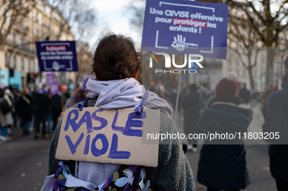 A demonstrator holds a placard reading ''no more rape'' during a protest to condemn violence against women, called by feminist organizations...