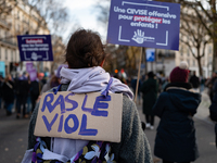 A demonstrator holds a placard reading ''no more rape'' during a protest to condemn violence against women, called by feminist organizations...