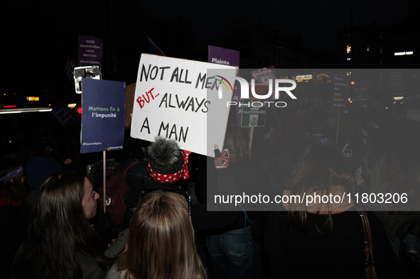 A demonstrator holds a placard reading ''not all men, but always a man'' during a protest to condemn violence against women, called by femin...