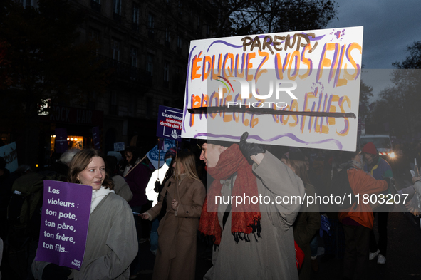 A demonstrator holds a placard reading ''Parents educate your sons'' during a protest to condemn violence against women, called by feminist...