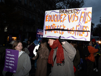 A demonstrator holds a placard reading ''Parents educate your sons'' during a protest to condemn violence against women, called by feminist...