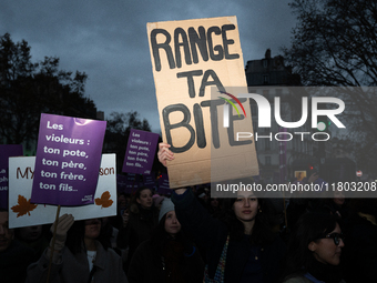 A demonstrator holds a placard reading ''put your cock away'' during a protest to condemn violence against women, called by feminist organiz...