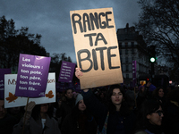 A demonstrator holds a placard reading ''put your cock away'' during a protest to condemn violence against women, called by feminist organiz...