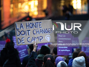 A demonstrator holds a placard reading ''shame must change sides'' during a protest to condemn violence against women, organized by feminist...