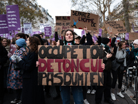 A demonstrator holds a placard reading ''take care of your ass, not mine'' during a protest to condemn violence against women, called by fem...