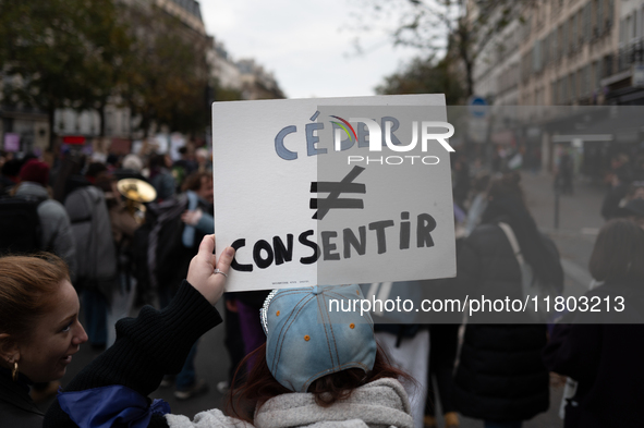 A demonstrator holds a placard reading ''to cede as opposed to to consent'' during a protest to condemn violence against women, called by fe...