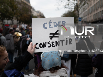 A demonstrator holds a placard reading ''to cede as opposed to to consent'' during a protest to condemn violence against women, called by fe...