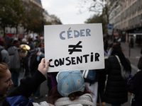 A demonstrator holds a placard reading ''to cede as opposed to to consent'' during a protest to condemn violence against women, called by fe...