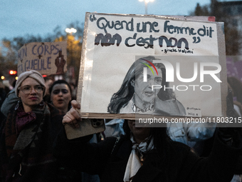 A demonstrator holds a placard reading ''when a woman says no, it's no, Gisele Halim'' during a protest to condemn violence against women, c...