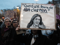 A demonstrator holds a placard reading ''when a woman says no, it's no, Gisele Halim'' during a protest to condemn violence against women, c...