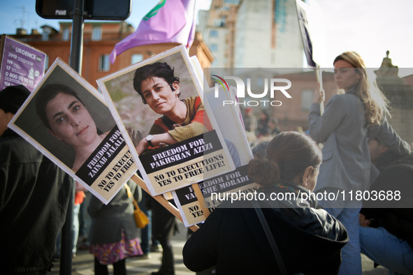 A woman holds portraits of Kurdish women condemned to the death penalty. Women from the collective NousToutes and other organizations such a...