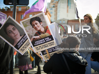 A woman holds portraits of Kurdish women condemned to the death penalty. Women from the collective NousToutes and other organizations such a...