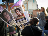 A woman holds portraits of Kurdish women condemned to the death penalty. Women from the collective NousToutes and other organizations such a...