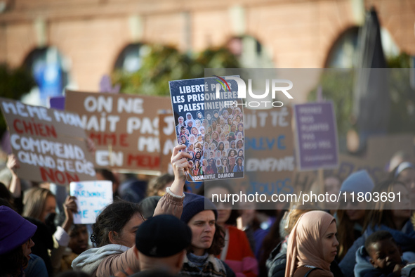 A protester holds a billboard reading 'Freedom for Palestinian women'. Women from the collective NousToutes and other organizations such as...